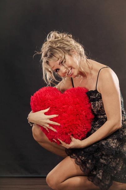 Mature woman hug big red heart  - Fotografie, Obrázek