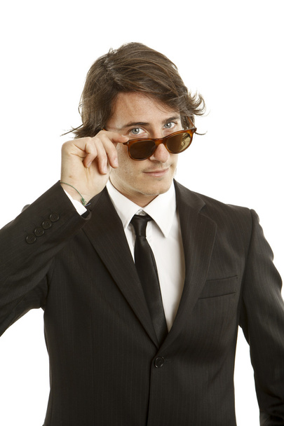 attractive young man wearing elegant black suit and sunglasses - Zdjęcie, obraz