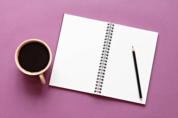 top view image of open notebook with blank pages and coffee cup on color background, ready for adding or mock up - Photo, Image