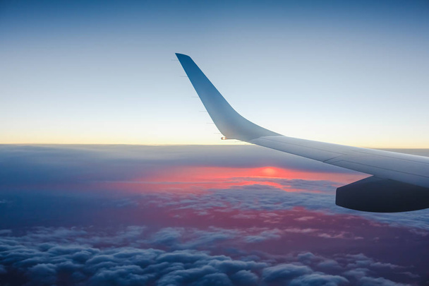 Wing of an airplane in the sunset - Foto, Imagen
