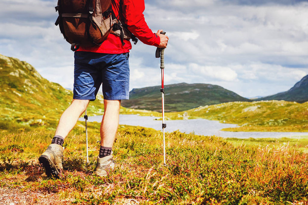 Hiker with backpack walking in Norway mountains. Fitness and healthy lifestyle outdoors - Zdjęcie, obraz