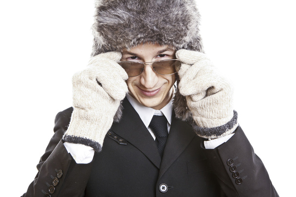 Attractive young man wearing elegant black suit,sunglasses and russian hat - Zdjęcie, obraz