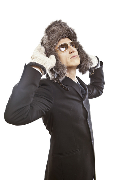 Attractive young man wearing elegant black suit,sunglasses and russian hat - Foto, afbeelding