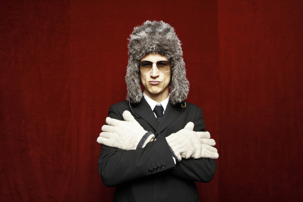 Attractive young man wearing elegant black suit,sunglasses and russian hat - Foto, immagini
