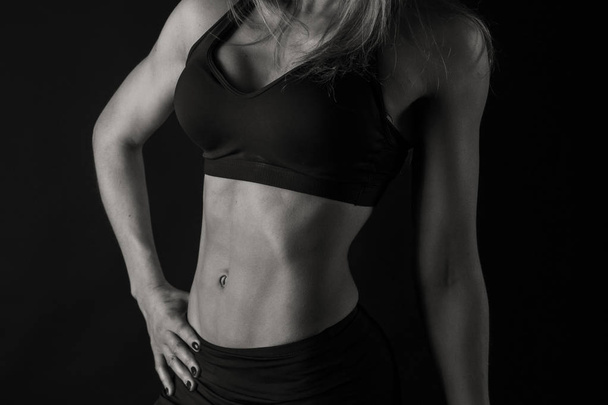 attractive fitness woman on a black background - Photo, Image