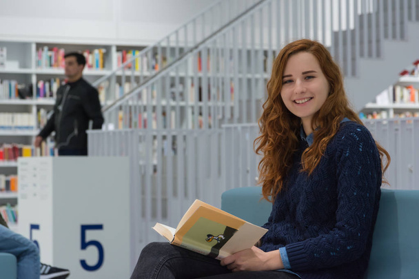 Clever University Student Studying in White Modern Library Books - Foto, imagen
