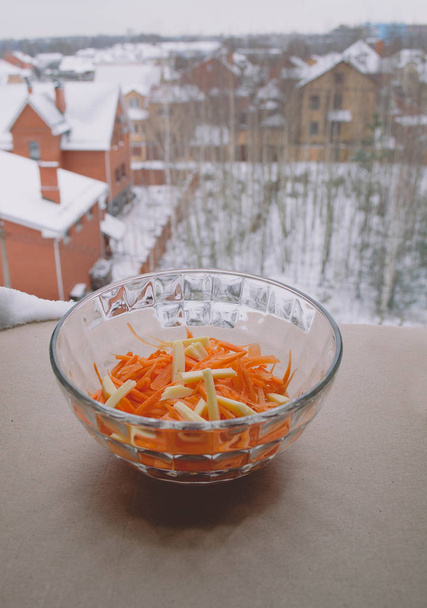 geriebene und ganze Möhren. Karottensalat in einer Salatschüssel auf dem Ta - Foto, Bild