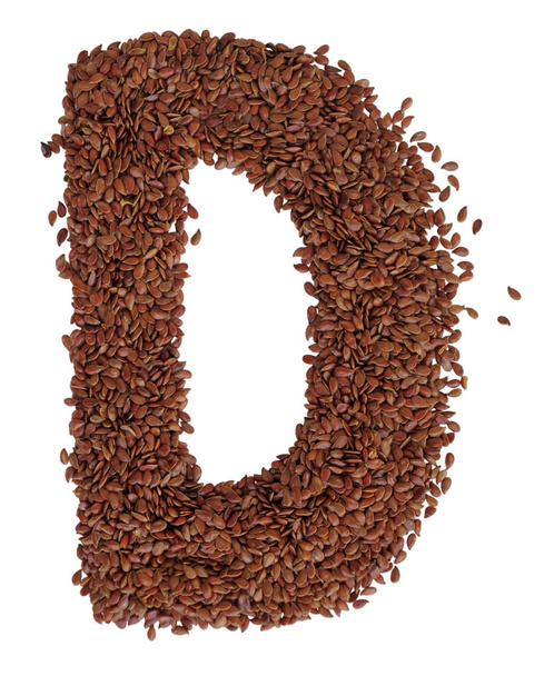 Letter D made with Linseed also known as flaxseed isolated on wh - 写真・画像