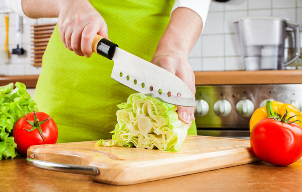 Woman's hands cutting vegetables - 写真・画像