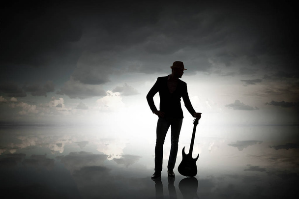 Elegant guitarist silhouette . Mixed media - Foto, imagen