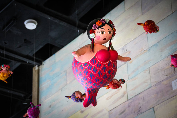 Fat toy mermaids hanging from the roof - Foto, immagini