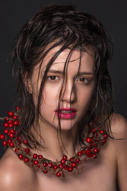 Emotional fashion portrait of beautiful women with bright makeup. Wet hair on her face. Studio photo on a black background. - Foto, afbeelding
