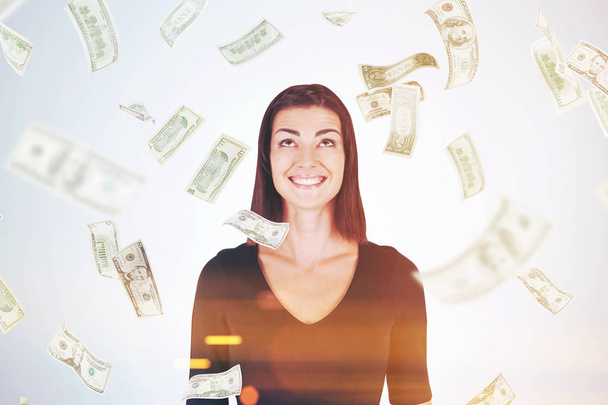 Happy woman in black, dollar bills falling - Foto, afbeelding