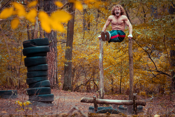 Homemade playground. Athlete swings abdominal muscles. - Photo, Image
