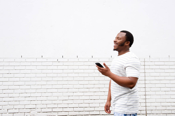 African american man using phone  - Фото, изображение