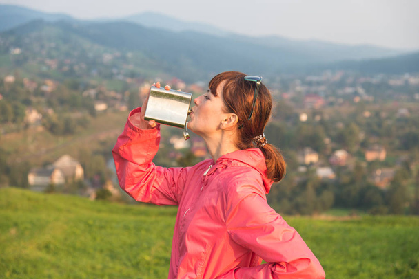 Girl drinking with a metal flask - Foto, Bild