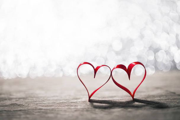 Two ribbon hearts on wood - Фото, изображение