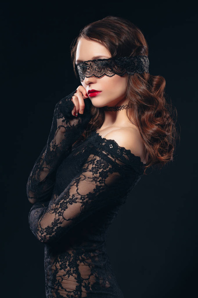 Sexy girl in black lingerie on black background. Erotic photoshoot charming attractive woman with a blindfold mask on her face. Perfect ass and beautiful makeup - Fotografie, Obrázek