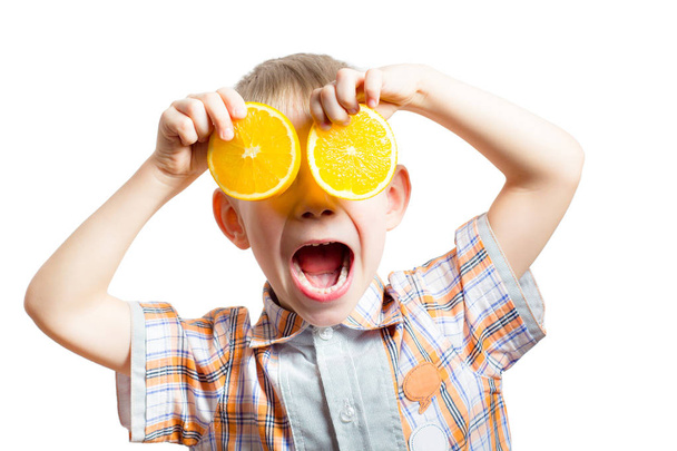 Happy funny boy with fresh oranges. - Foto, immagini
