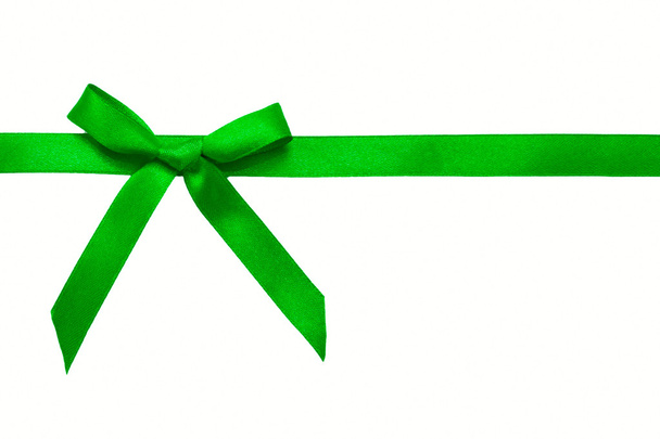 Green satin bow on a satin ribbon. Ready for your text or logo. - Photo, Image