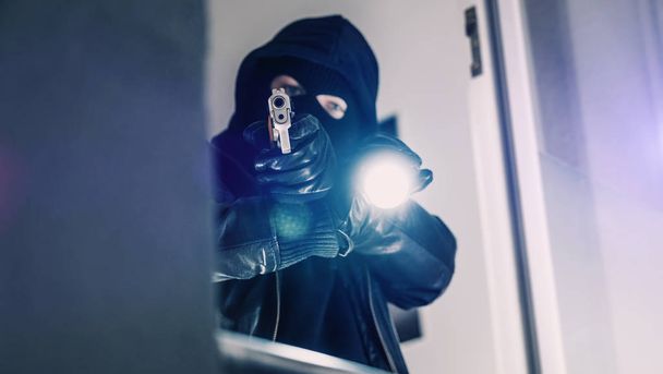 Masked burglar with pistol gun - Foto, afbeelding