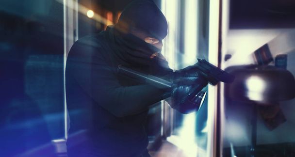 Masked burglar with pistol gun - Фото, изображение