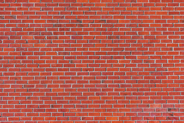 Red brick wall with many tiles on a building facade - Photo, Image