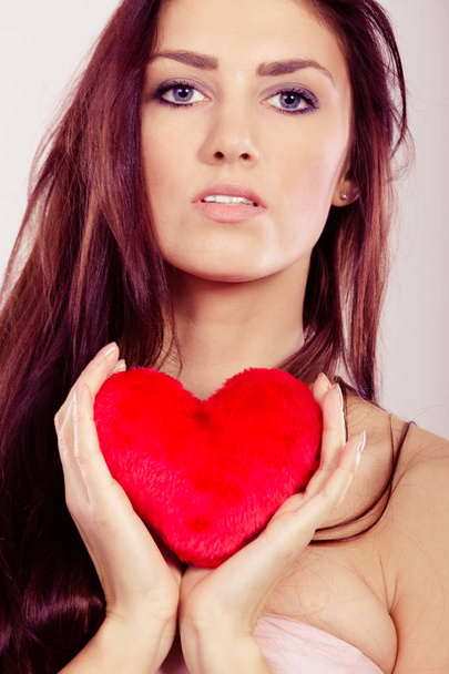 Beautiful woman holds red heart  - 写真・画像