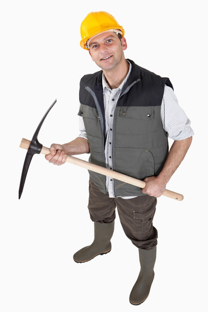 Bricklayer holding pickaxe - Foto, afbeelding