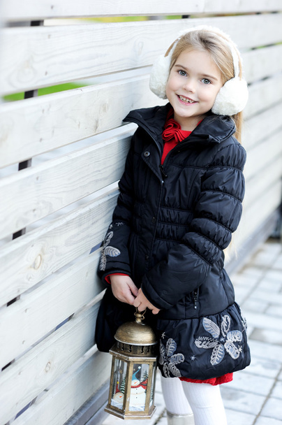 Portrait of little girl in white earmuffs - Φωτογραφία, εικόνα