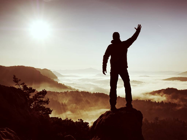 Happy man with raised arms gesture triumph  on exposed cliff. Satisfy hiker - Photo, Image