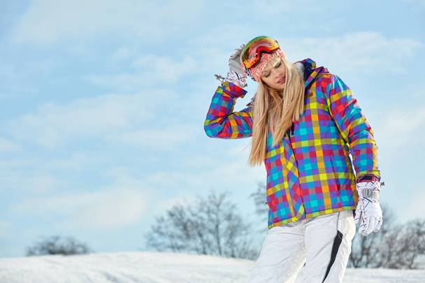 Sport girl with snowboard high in the winter snowy mountains.   - 写真・画像