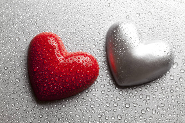 Two hearts dewy water on a metal plate - Φωτογραφία, εικόνα