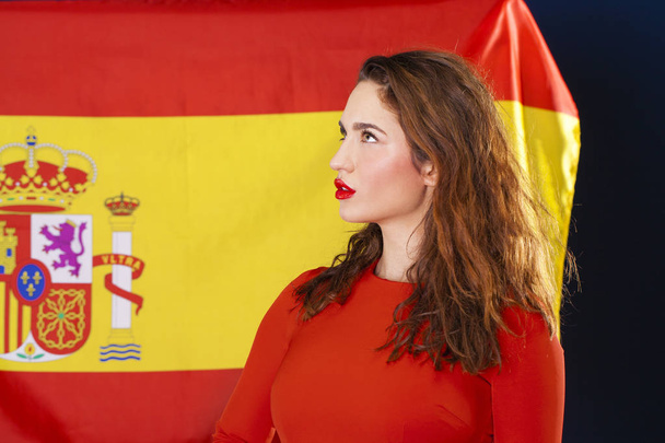 Young woman on the background of the Spanish flag - Fotó, kép