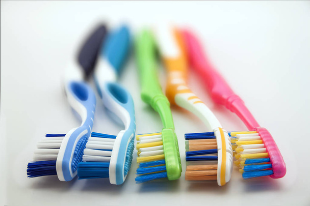 Colorful toothbrushes on white background with copy space. Macro - Photo, Image