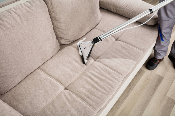 Person Cleaning Sofa - Фото, изображение
