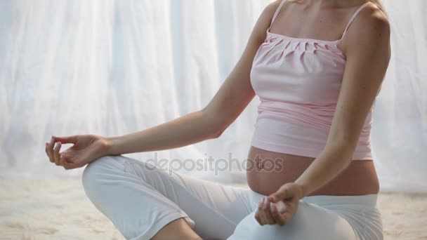 Pregnant woman in yoga pose - Video