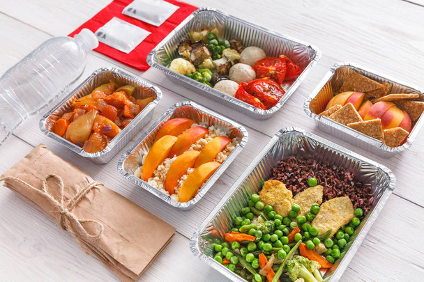 Healthy food take away in boxes, top view at wood - Photo, Image