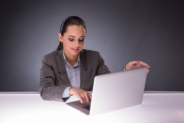 Businesswoman with laptop in business concept - 写真・画像
