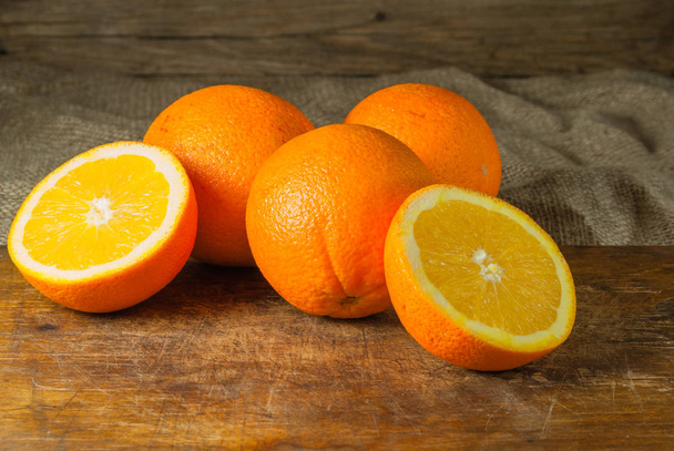 Oranges Fruits and Orange Slice on Wooden Table and Retro Fabric - Foto, Imagem