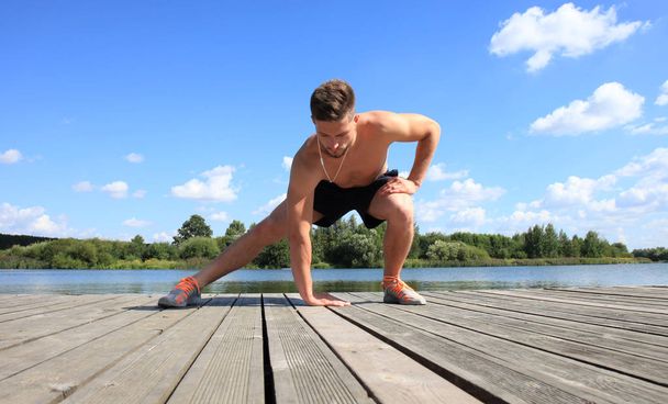 Athletic Man Stretching Before Workout - Foto, afbeelding