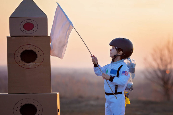 Adorable little boy, dressed as astronaut, playing in the park w - Photo, Image