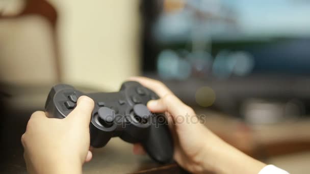 Man playing video game with a joystick. close-up of childrens hands - Imágenes, Vídeo