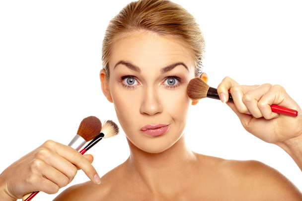 Humorous image of woman with makeup brushes - Photo, Image
