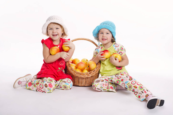two funny girls with apple harvest - Foto, afbeelding