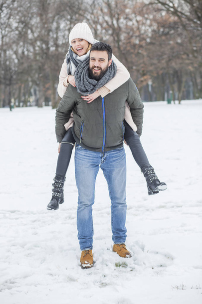 Happy couple walking in winter park  - Foto, immagini