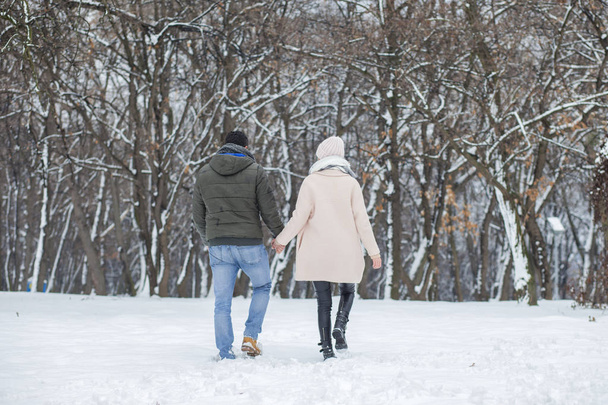 Happy couple walking in winter park  - 写真・画像