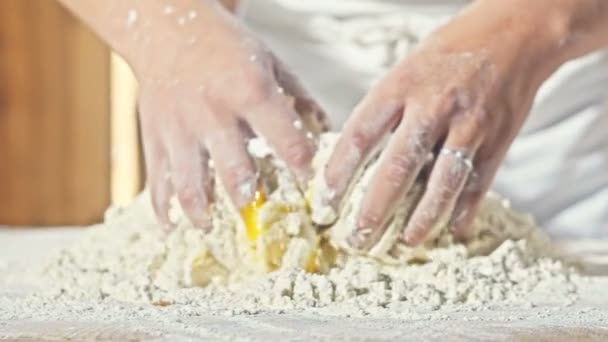 Childrens hands knead the dough with eggs close up - Video, Çekim