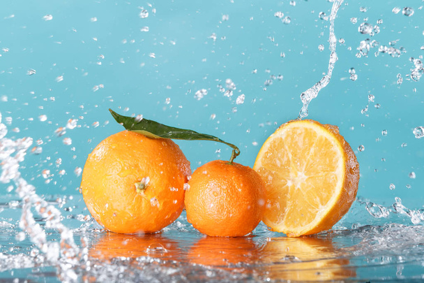 fresh orange with water splash on green background - Photo, Image