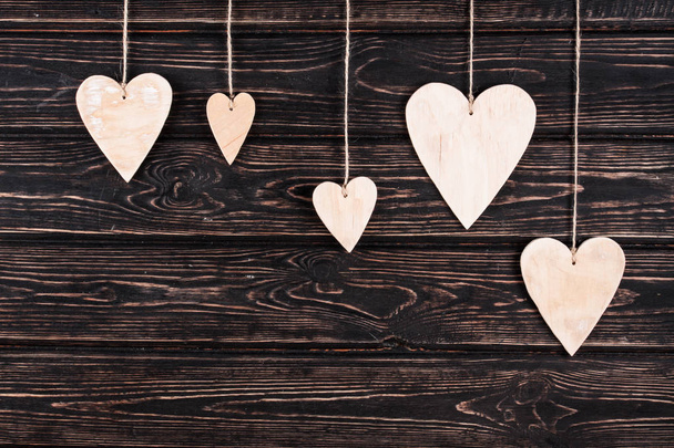 Wood hearts on wood background - 写真・画像